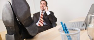 Businessman talking on telephone with feet up